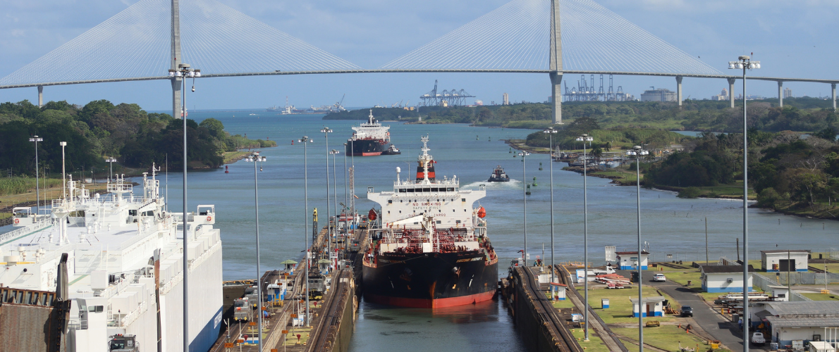 A view of the Miraflores Locks, Centennial Bridge, and a container ship passing through the Panama Canal.