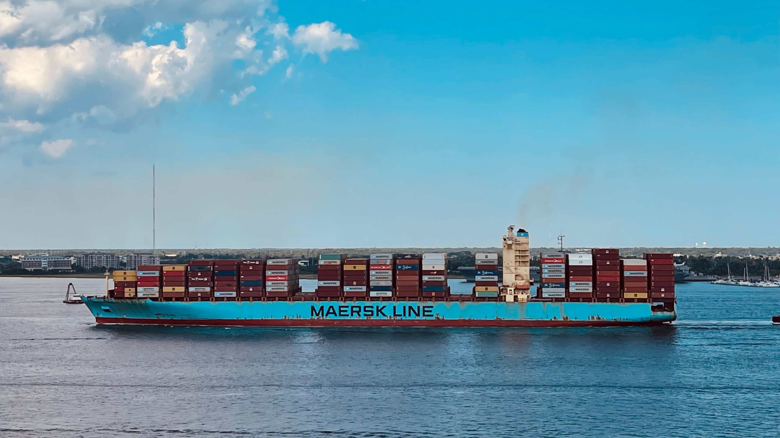 maersk shipping line container ship delivering shipping containers from port